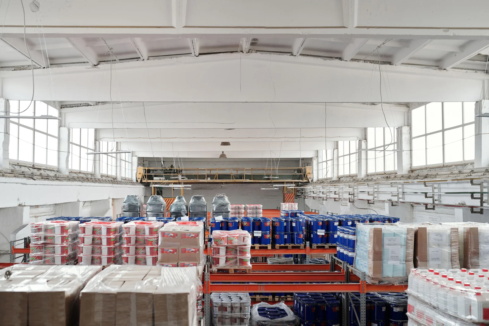 A bright warehouse with goods organised on industrial shelving.